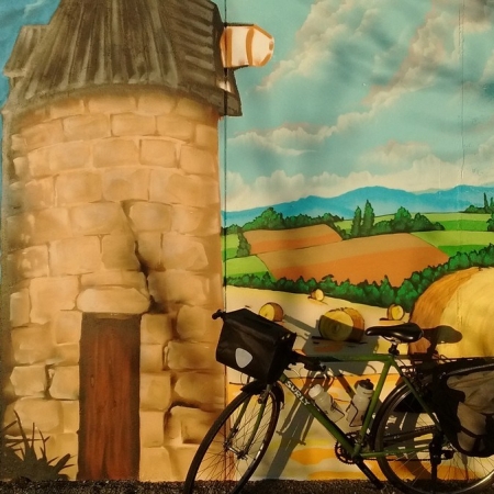 A bicycle in front of a mural in Mural in Serignac-Peboudou, France
