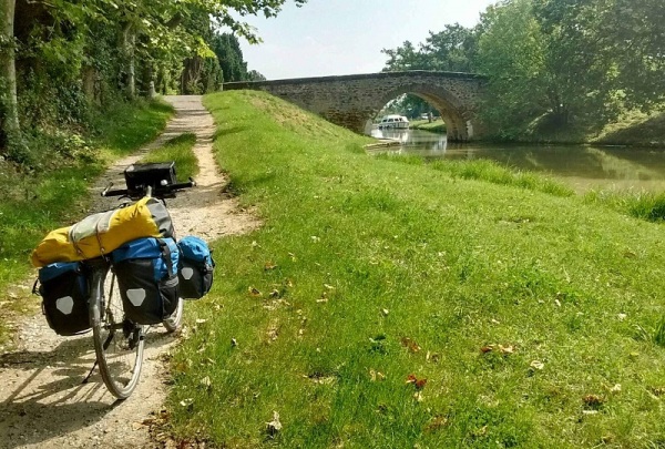 Touring bicycle on a dirt path next to the Canal du Midi, France.